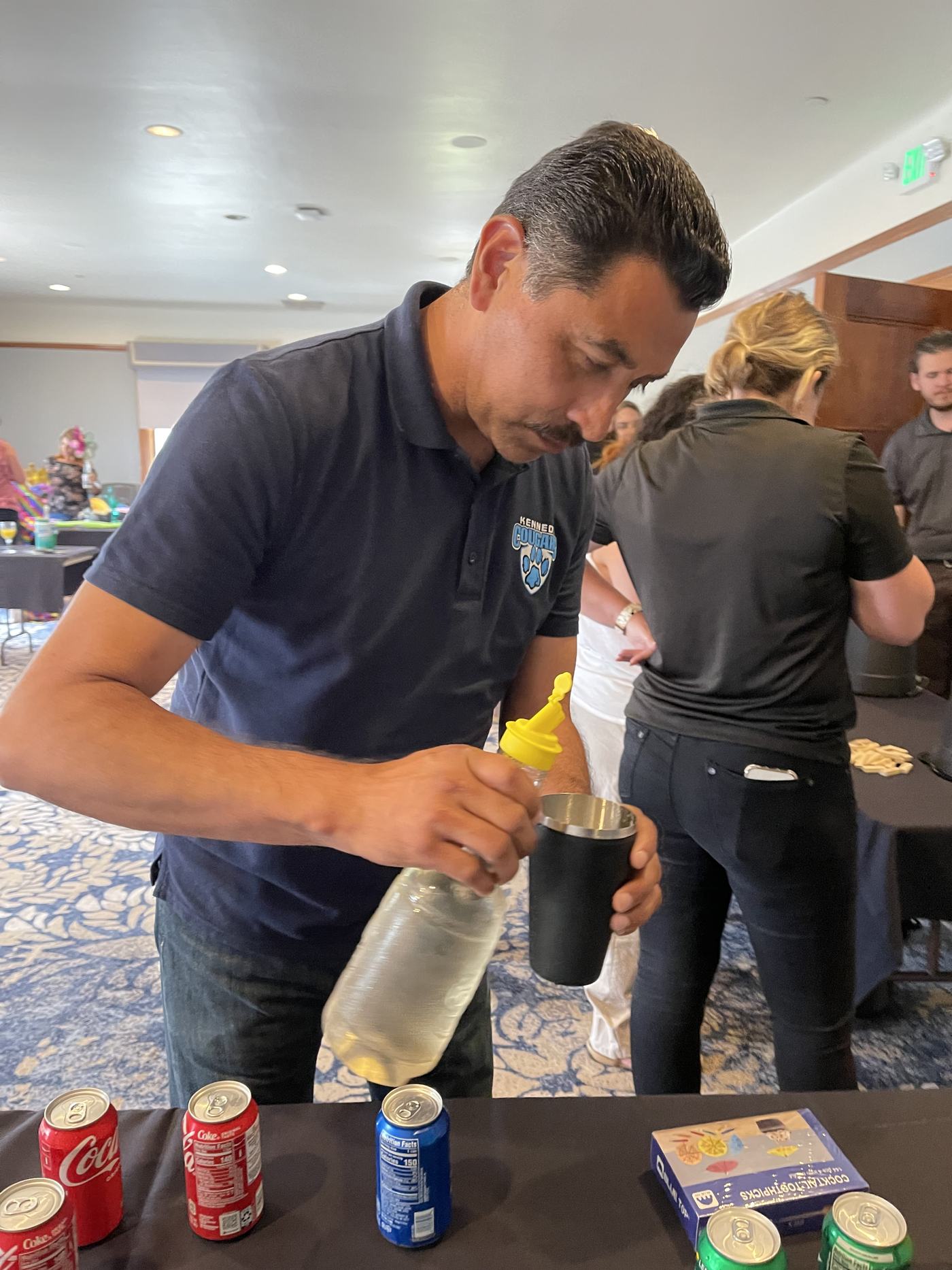 A participant measuring an ingredient for a signature drink