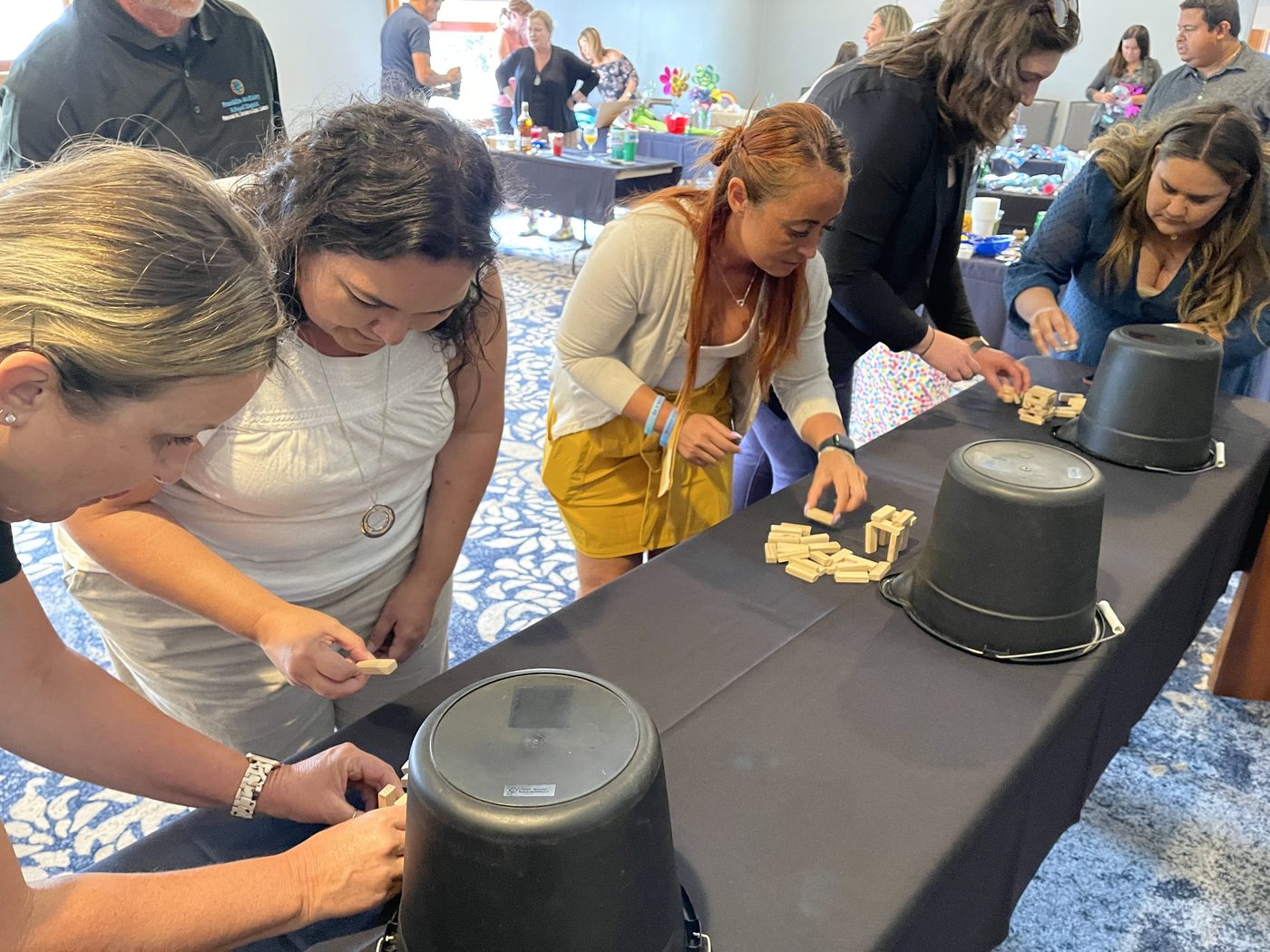 Teammates leaning into a table challenge