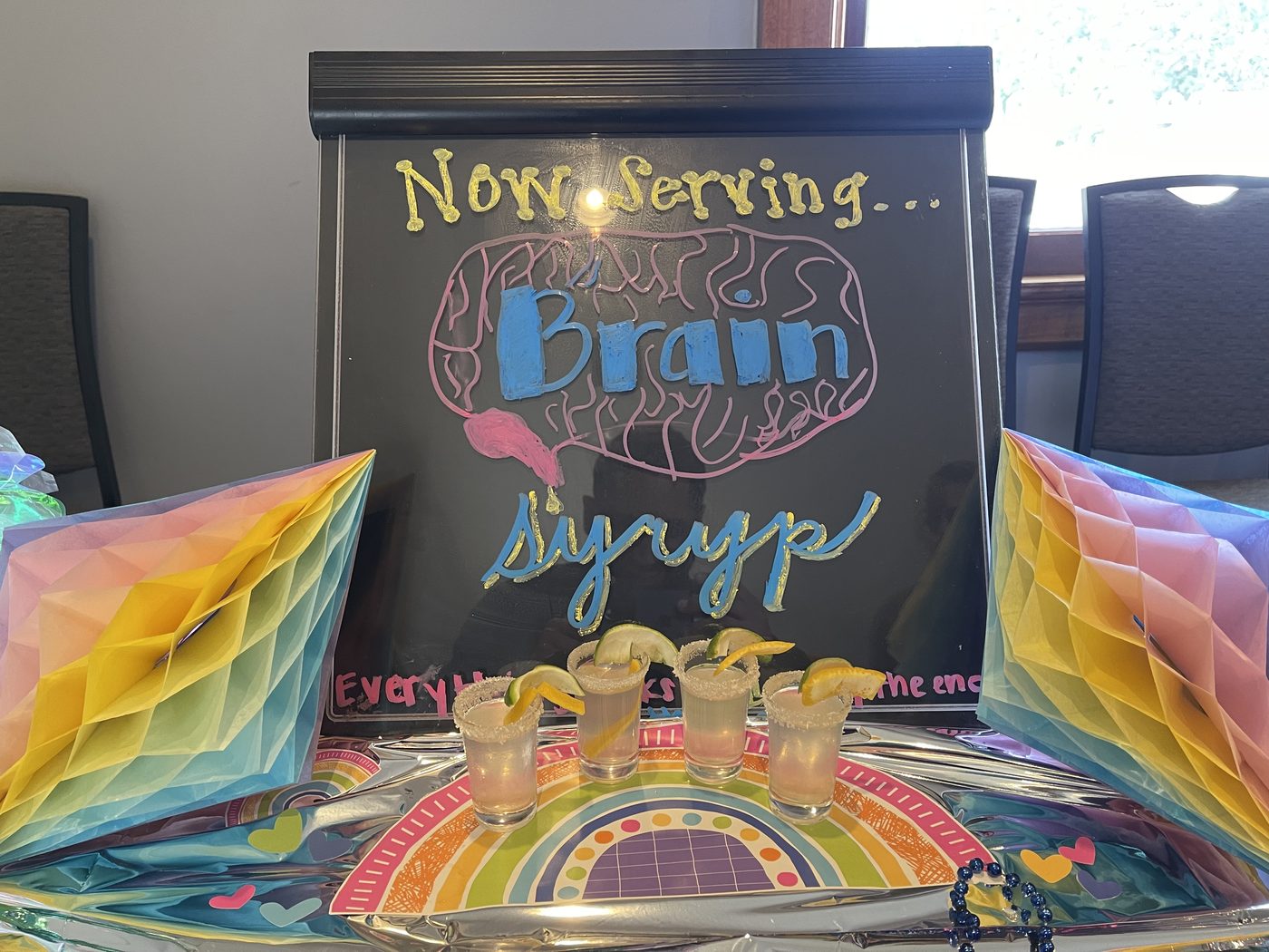 A handmade cocktail menu surrounded by colorful decorations