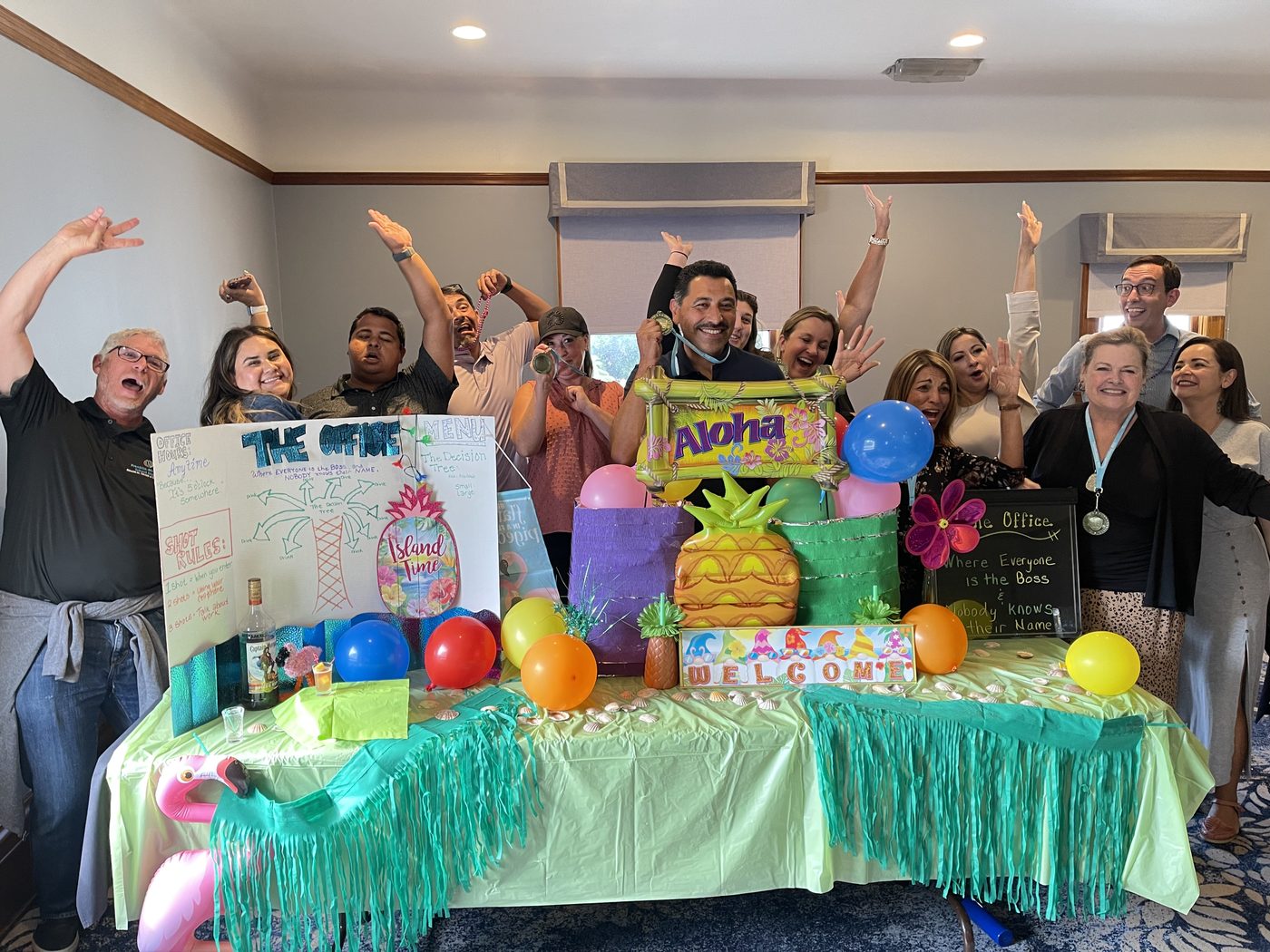 A group celebrating its finished cantina with raised arms