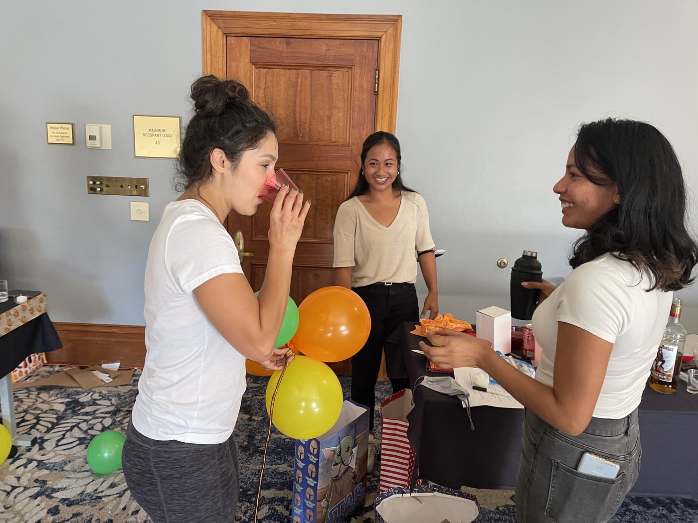 Participants smiling and sharing a drink creation