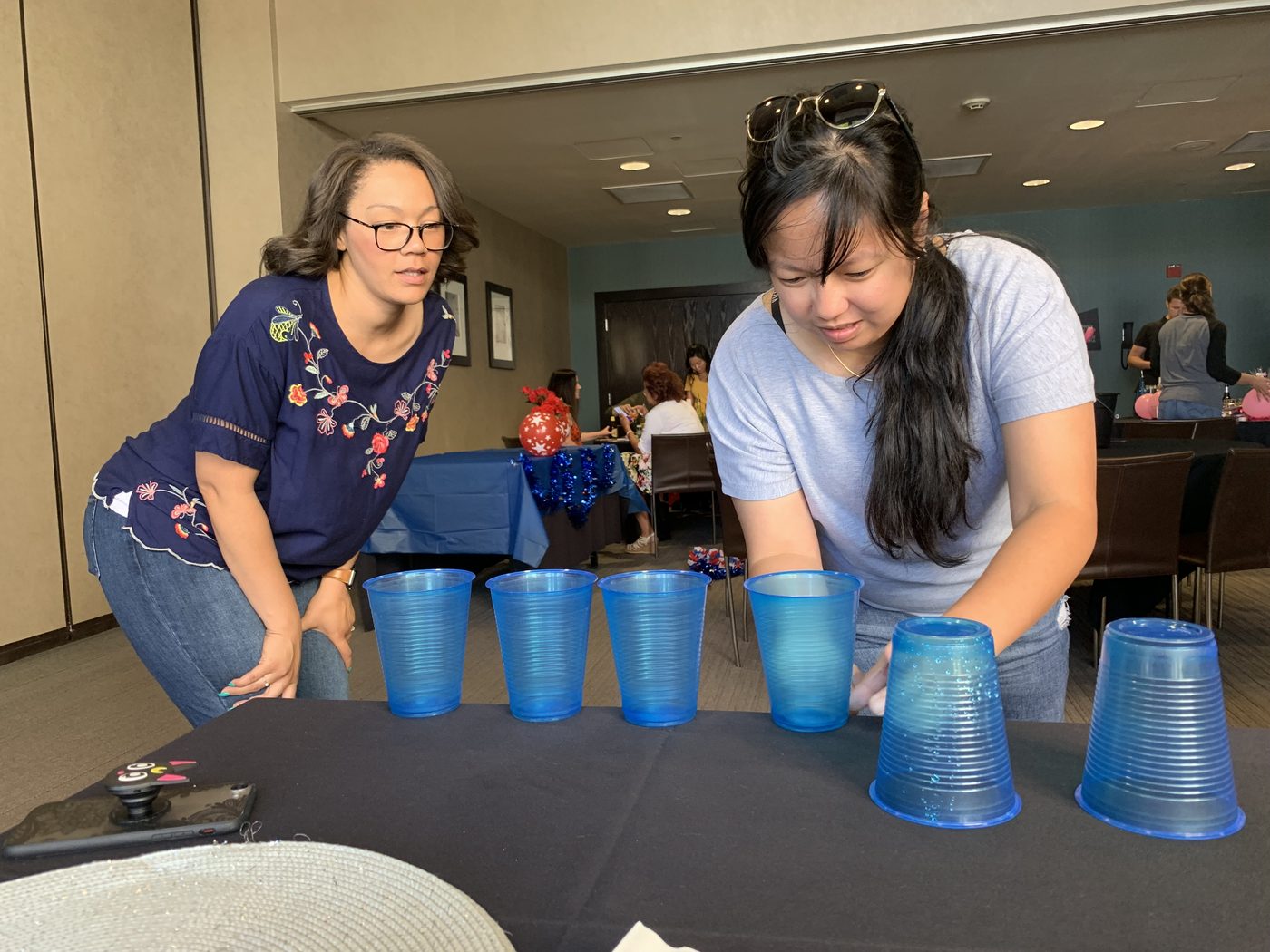 Teammates arranging cups during a timed challenge