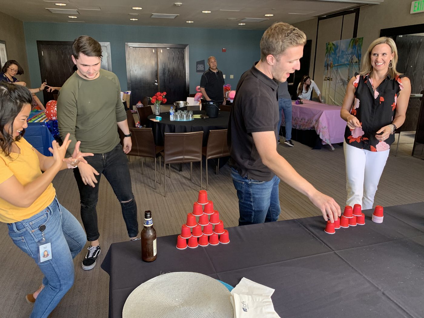 Participants building a cup pyramid together