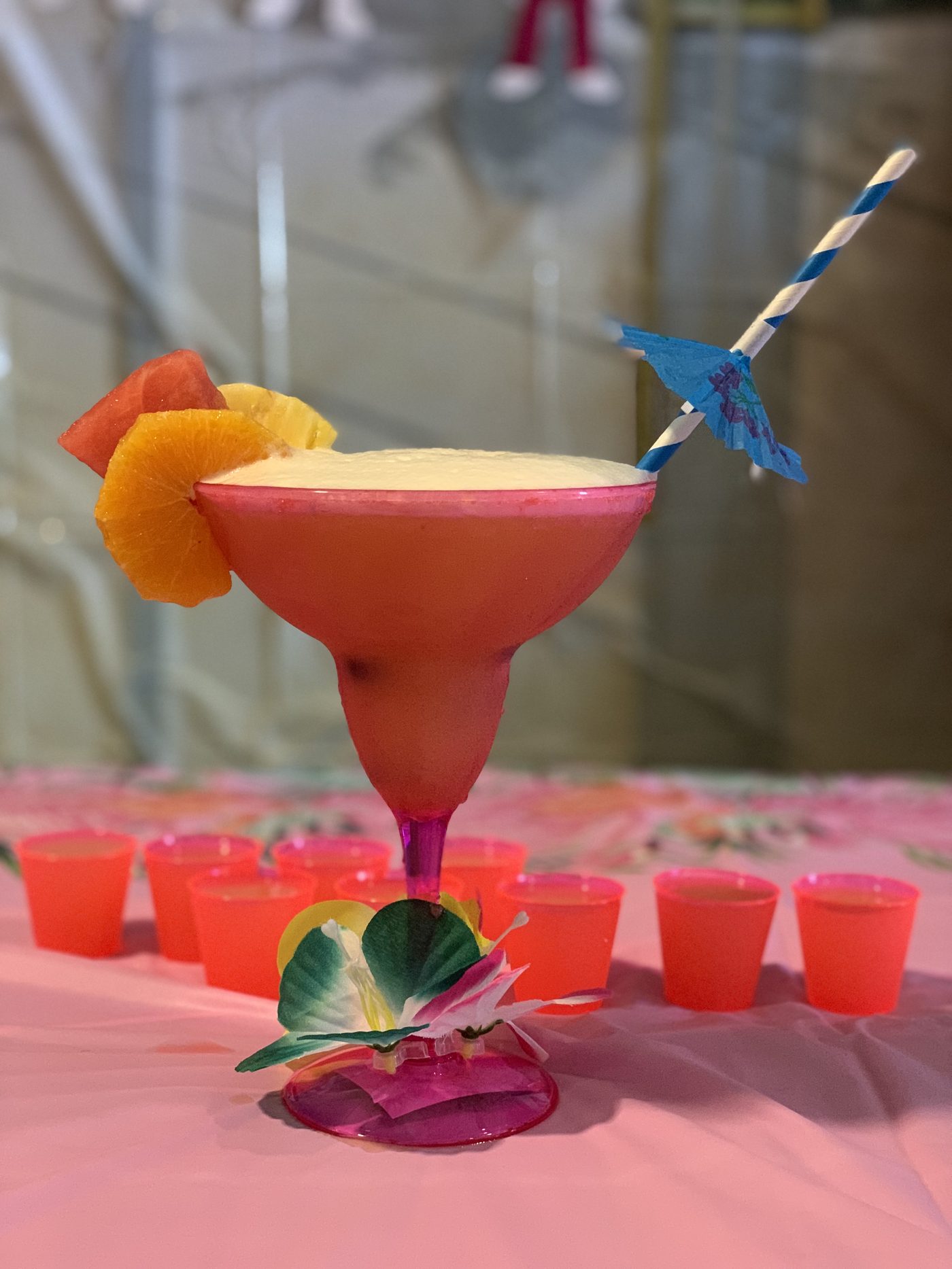 A colorful finished drink beside the team’s tasting cups