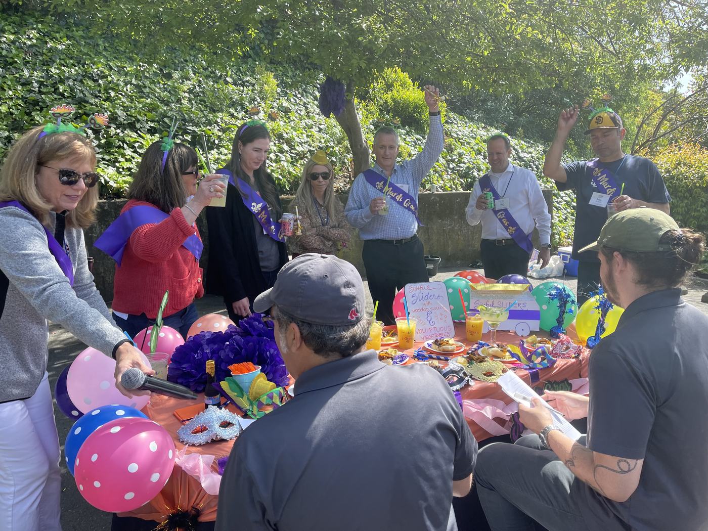 An outdoor cantina with balloons and guests gathered around
